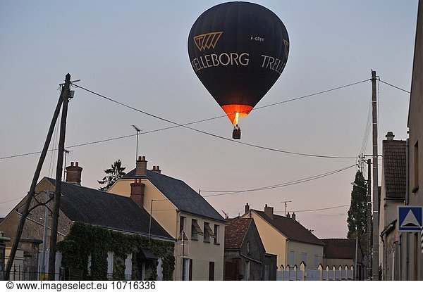 hot-air balloon in flight over a village of Beauce  Eure-et-Loir department  Centre region  France  Europe.