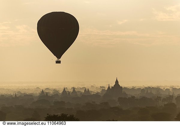Hot-air Balloon in flight over temples of Bagan  Myanmar  Asia