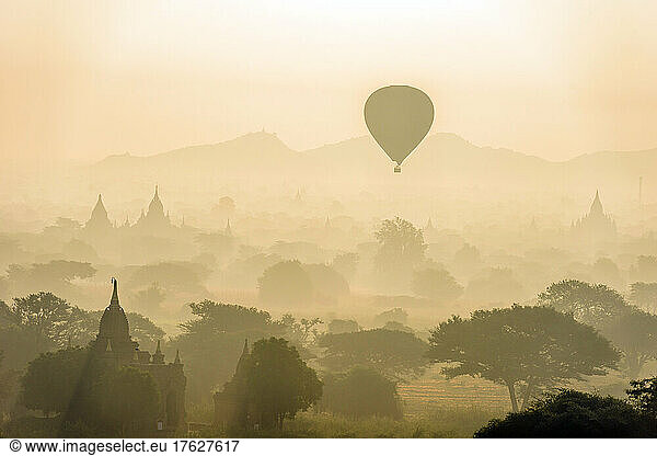 Hot air balloon in the air above the plain of temples in Mandalay