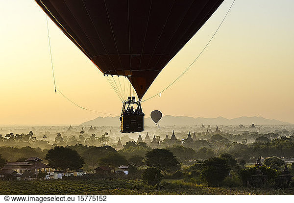 Hot air balloon over landscape with temples at sunset  Bagan  Myanmar.