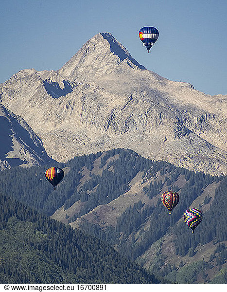 Hot air balloons flying against mountain in Apsne Colorado