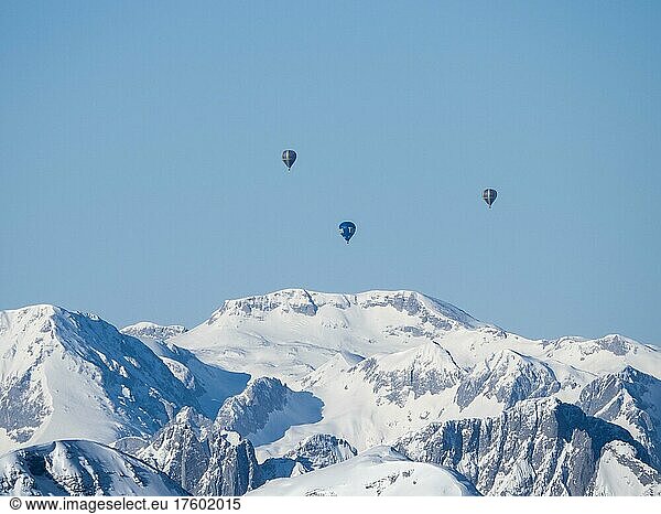 Hot air balloons flying over snow-covered Alpine peaks  view from Krippenstein  Salzkammergut  Upper Austria  Austria  Europe