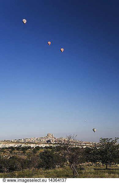Hot air balloons over the village of Uchisar  Cappadocia  Turkey  Europe