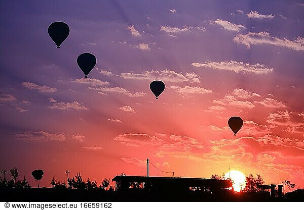 Hot air balloons silhouette in Goreme valley at sunrise  Cappadocia  Turkey.