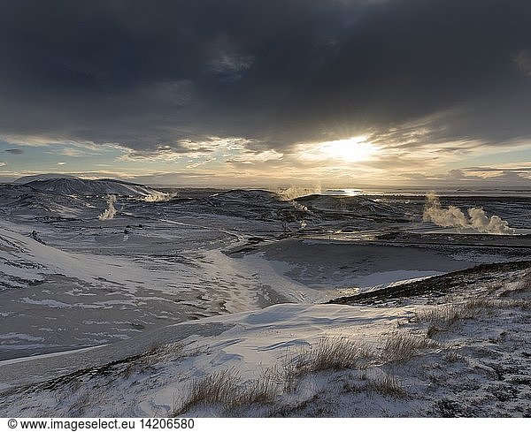 Hot steam rising from the geothermal power plant Bjarnaflag near the vulcano Krafla in the snowy highlands of wintery Iceland  lake Myvatn in the background. europe  northern europe  iceland  February
