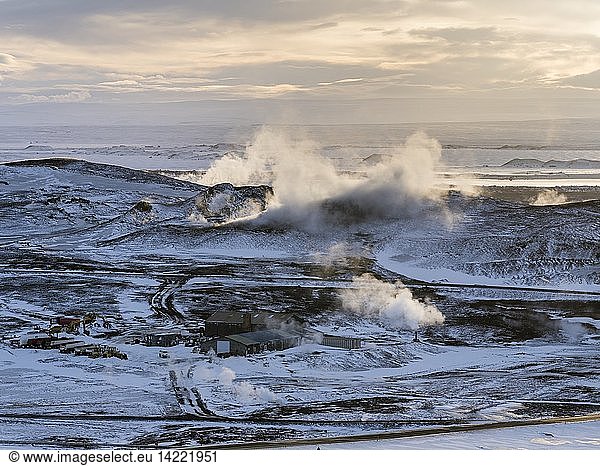 Hot steam rising from the geothermal power plant Bjarnaflag near the vulcano Krafla in the snowy highlands of wintery Iceland  lake Myvatn in the background. europe  northern europe  iceland  February