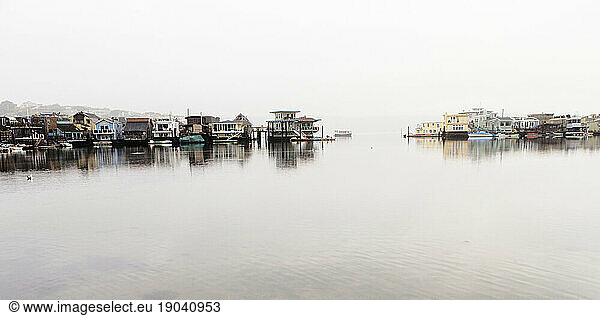 Houseboats in the morning on the foggy horizon.