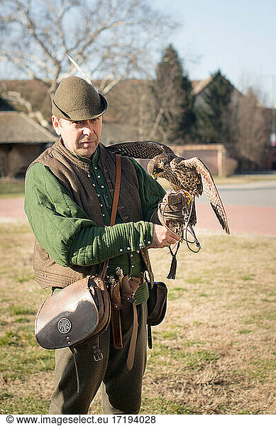 Hunter with a falcon with open wings