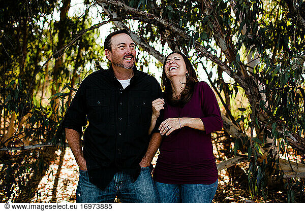 Husband & Wife Laughing Under Tree in Chula Vista