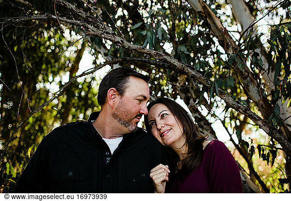 Husband & Wife Posing Under Tree at Park in Chula Vista