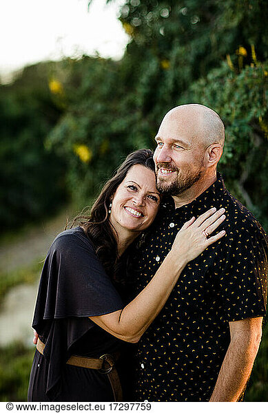 Husband & Wife Snuggling in Garden in San Diego