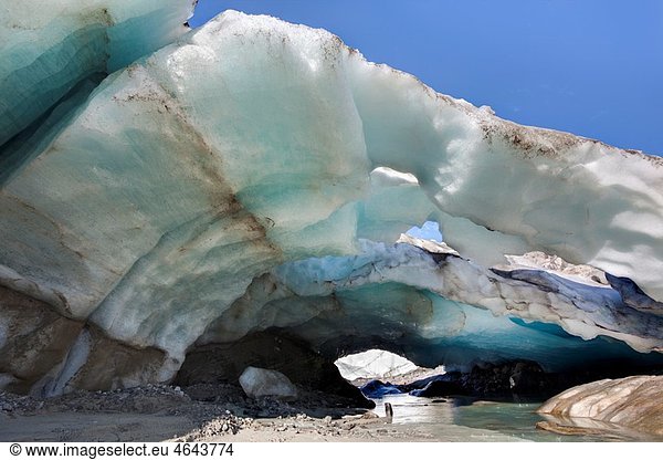Ice cave and glacier snout of Schlatenkees  source of the creek Schlatenbach parts of the have collapsed and melted away Therefore an ice cave with two openings exists The Schlatenkees is one of the biggest glaciers in Austria and retreating rapidly