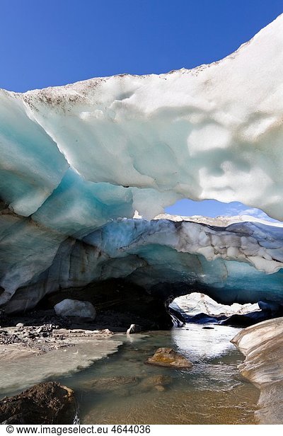 Ice cave and glacier snout of Schlatenkees  source of the creek Schlatenbach parts of the have collapsed and melted away Therefore an ice cave with two openings exists The Schlatenkees is one of the biggest glaciers in Austria and retreating rapidly