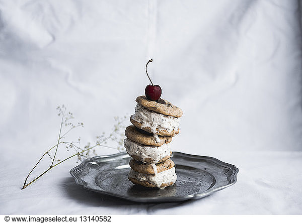 Ice cream with cookies served in plate on textile