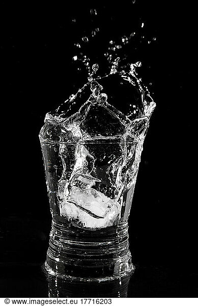 Ice Cube Falling Into A Glass Of Water