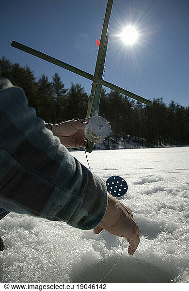 Ice fishing on a pond  Maine.