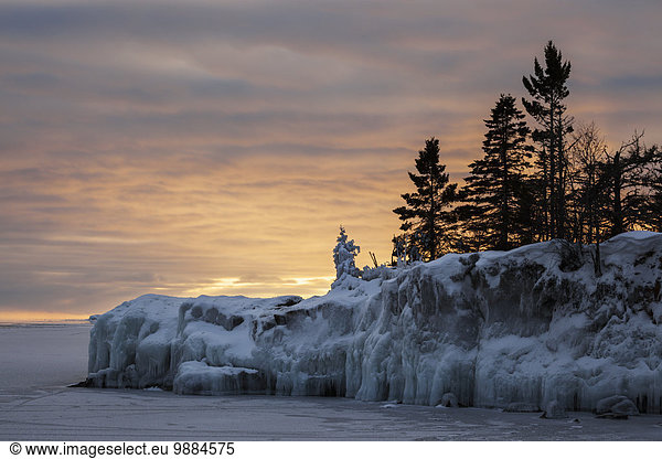 Ice on Lake Superior at sunrise; Grand Portage  Minnesota  United States of America