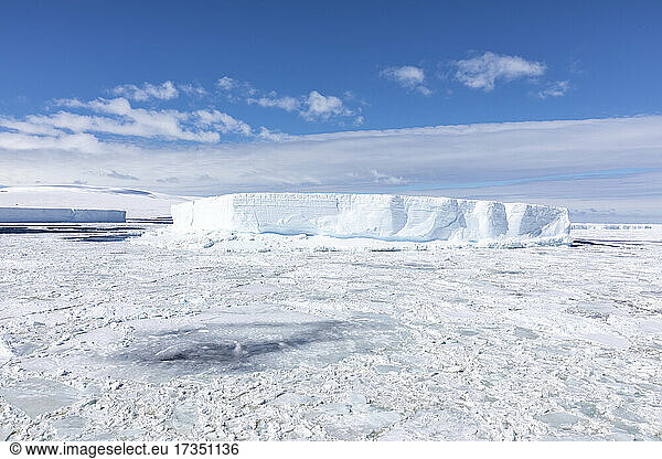 Iceberg amongst winter sea ice breaking up in the Weddell Sea  Antarctica  Polar Regions