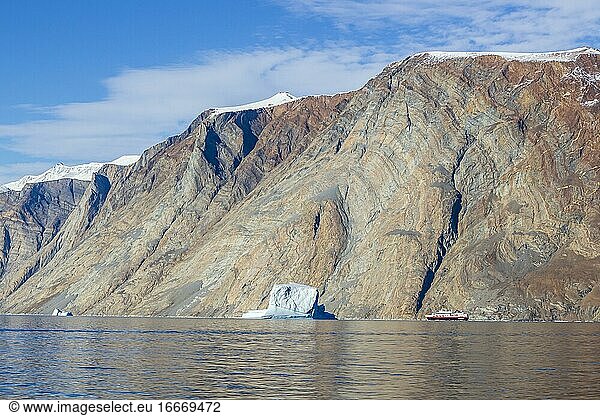 Iceberg and cruise ship in fjord  Kaiser-Franz-Joseph-Fjord  east coast Greenland  Denmark  Europe