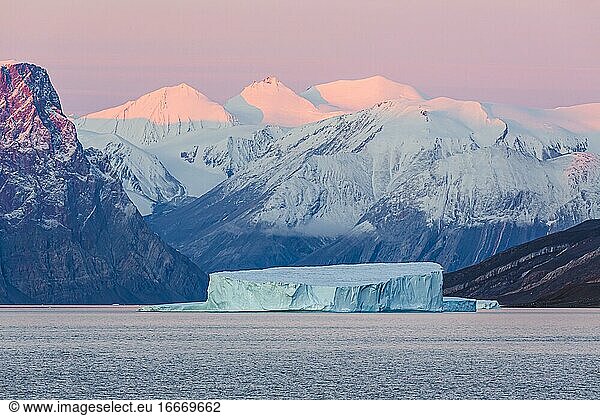 Iceberg in fjord  sunrise  Emperor Franz Joseph Fjord  east coast Greenland  Denmark  Europe