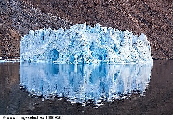 Iceberg in front of rock in fjord  Kaiser-Franz-Joseph-Fjord  east coast Greenland  Denmark  Europe