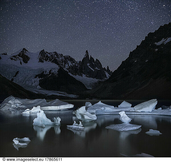 Icebergs dot the shore of Laguna Torre  illuminated at night in