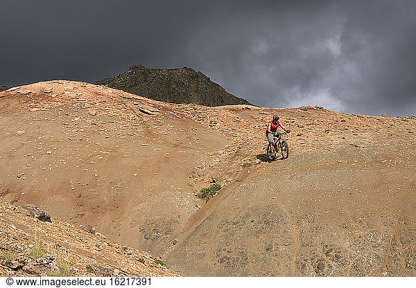 Iceland  Man mountain biking in hilly landscape