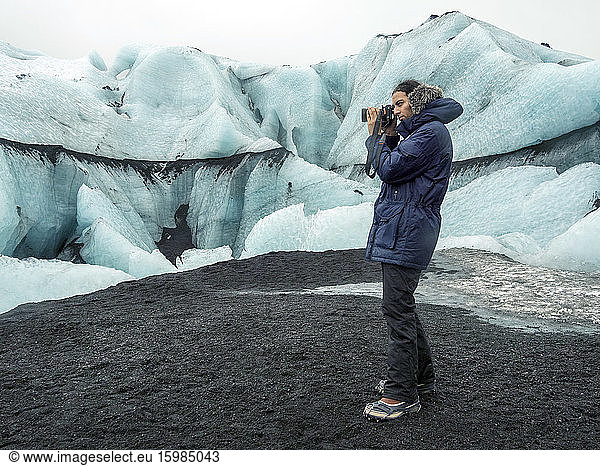 Iceland  man taking photo by Eyjafjallajokull