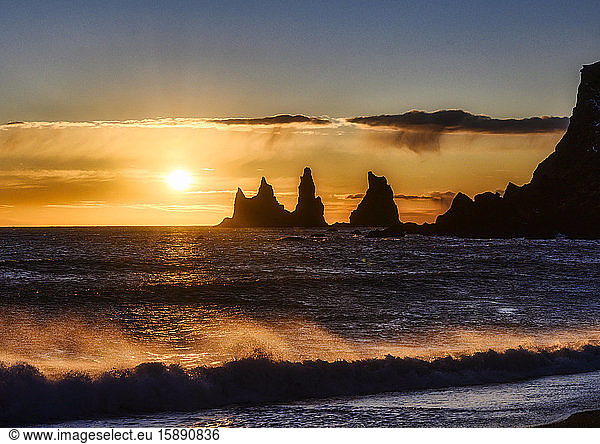 Iceland  Silhouettes of Reynisdrangar sea stacks at moody sunset