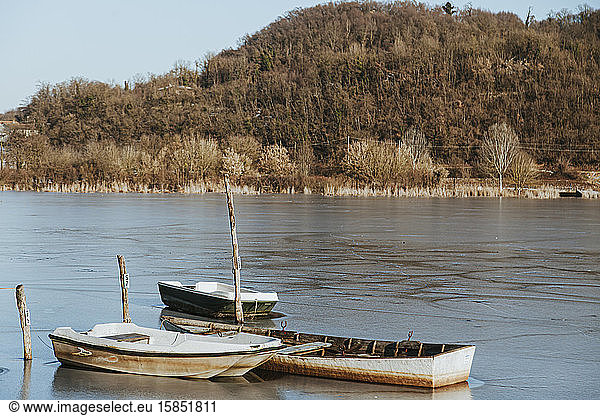 Icy Rural Landscape  three boats on a frozen lake