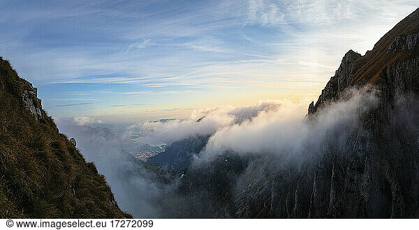 Idyllic shot of mountain covered by clouds during sunrise at Bergamasque Alps  Italy