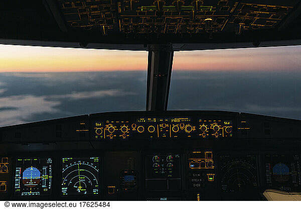 Idyllic sunset seen through illuminated cockpit
