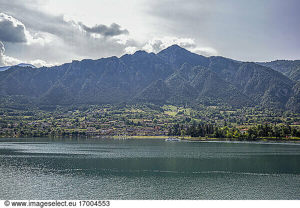 Idyllic view of Lake Idro against mountain ranges and sky