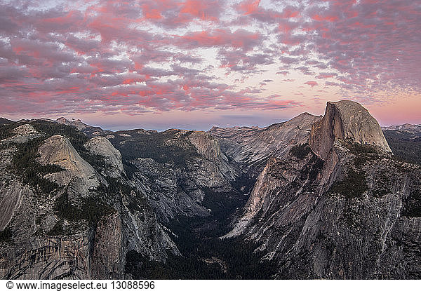 Idyllic view of mountain ranges against dramatic sky during sunrise at Yosemite National Park