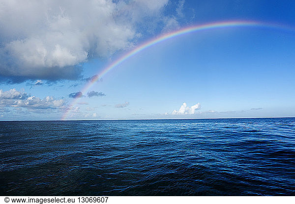 Idyllic view of rainbow over sea