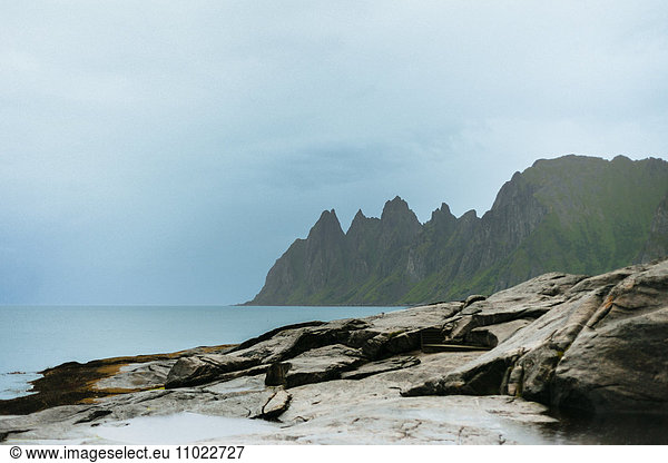 Idyllic view of rocky mountains by sea