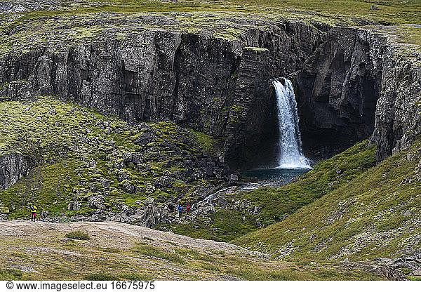 Idyllic view of tourists at Folaldafoss waterfall  Eastern Region  Iceland
