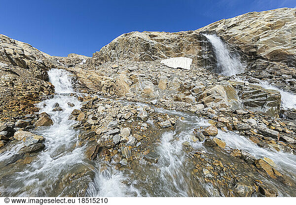 Idyllic waterfall amidst rocks below blue sky  Carinthia  Austria