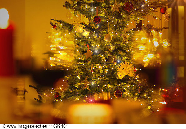 Illuminated Christmas tree with ornaments and string lights