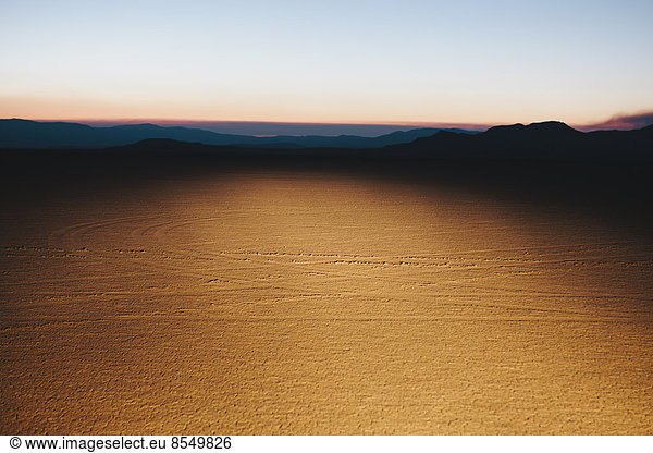 Illuminated desert landscape  dusk