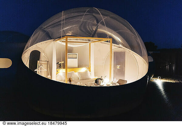 Illuminated dome tent at night
