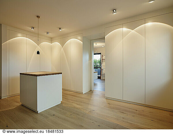 Illuminated dressing room in modern penthouse