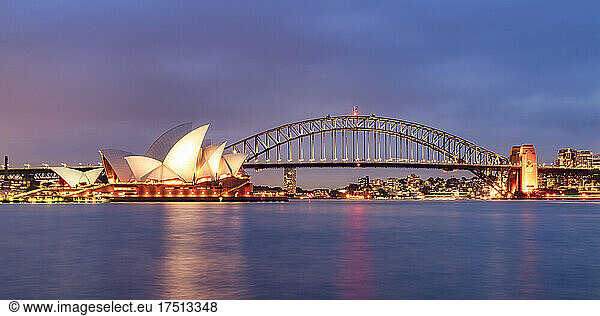 Illuminated Sydney Harbor Bridge over river against sky at dusk  Australia