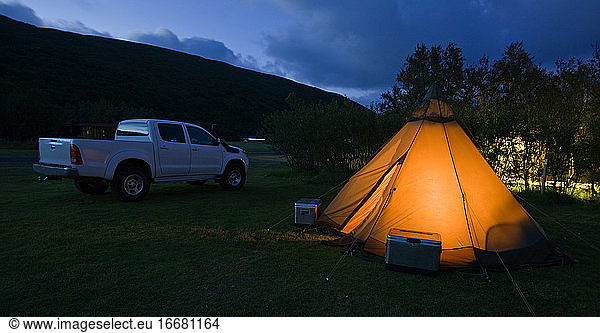 illuminated tent on campsite in Iceland