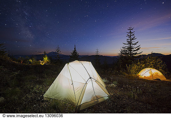 Illuminated tents against on field star field