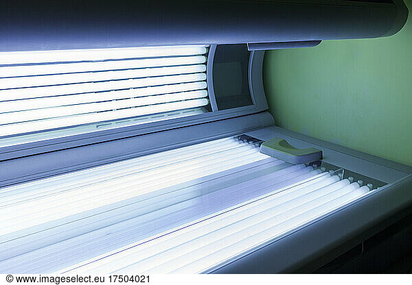 Illuminated ultraviolet light therapy bed at health spa