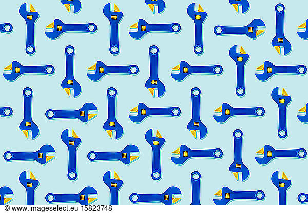 Illustration of rows of blue adjustable toy wrenches