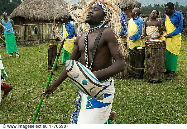 In a small village  men dress as warriors and perform traditional dance while others play drums.; Volcanoes National Park  Rwanda