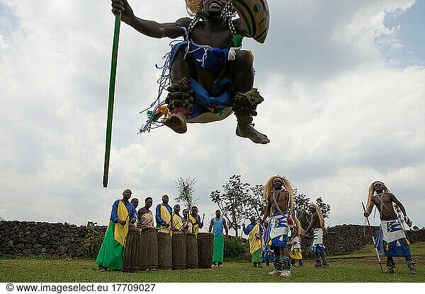 In a small village  men dress as warriors and perform traditional dance while others play drums.; Volcanoes National Park  Rwanda