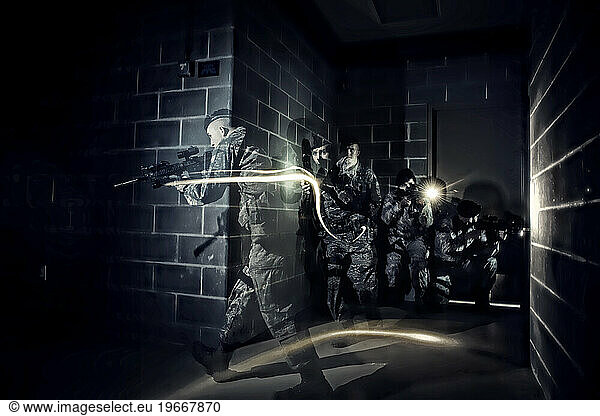 In pitch darkness  Air Force Security Forces members tactically move through a building using only the flashlights mounted on their weapons during hostage training.